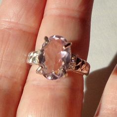 This Gorgeous, Morganite ring has a 10mm x 14mm faceted, lavender, sparkling gemstone, set in a Sterling Silver ring Setting, (hallmarked 925,) with six small sparkling White Sapphires, (3 tiny accent stones on each side.) This is a new casting, with a size 7 ring, and a flawlessly Beautiful large Gemstone. It would make a treasured gift for that special lady, (even if that be yourself.) Lavender Solitaire Rings For Formal Events, Lavender Solitaire Rings For Formal Occasions, Oval Amethyst Ring With Diamond Cut, Oval Diamond Cut Amethyst Ring, Classic Faceted Gemstones For Anniversary, Formal Oval Faceted Crystal Ring, Formal Faceted Oval Crystal Ring, Faceted Gemstones For Anniversary In Fine Jewelry Style, Classic Oval Faceted Topaz Ring