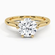 a yellow gold engagement ring with a round cut diamond