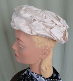 "This is a chic, vintage, beige hat, that dates from the 1950s or 60s. No labels or tags. It is a pillbox style. It features a double layer of fabric, overlapping leaves. The inside is a formed mesh. It measures 21\" around the inside. It is in very good, vintage condition. No soil or stains, there is gently wear around the inside edge. Nice & clean. Lovely!" Fitted Retro Cream Hat, Vintage Adjustable Fascinator With Structured Crown, Retro Fitted Cream Hat, Retro Cream Hat, Classic Beige Hat For Evening, Retro Cream Hat With Curved Brim, Cream Cloche Hat For Evening, Beige Cloche Hat For Church, Vintage Beige Fascinator For Evening