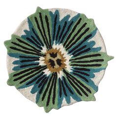 a blue and green flower rug on a white background with black, brown, and tan accents