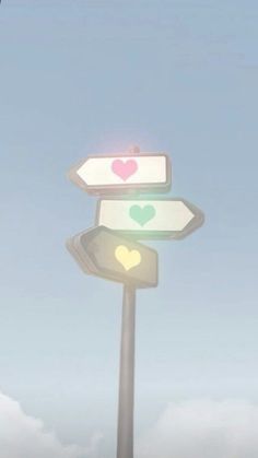 a street sign with hearts painted on it