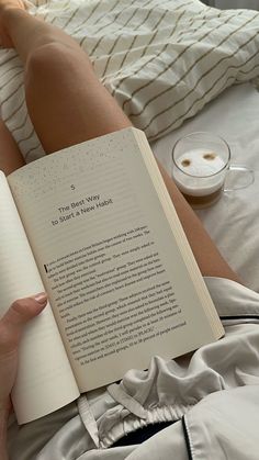 a person laying in bed with their legs crossed and holding an open book that reads the best way to sleep