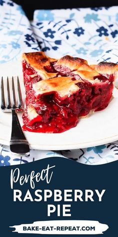 a piece of raspberry pie on a white plate with a fork and blue floral table cloth