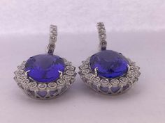 For Sale on 1stDibs - Natural Oval Tanzanite and Diamonds Earrings is set in 14K white Gold. Total weight of Tanzanite is 16.90 Carat and Total Diamond is 1.18 Carat. The earring Diamond Ball Earrings, Oval Tanzanite Earrings, Tanzanite Diamond Earrings, Oval Tanzanite Gemstone Earrings, Luxury Tanzanite Drop Earrings, Luxury Tanzanite Gemstone Earrings, Luxury Blue Tanzanite Earrings, Art Deco Drop Earrings, Emerald Diamond Earrings