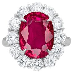 Crafted with meticulous attention to detail, this exquisite natural Ruby gemstone hails from the legendary mines of Mogok, Burma. Its captivating beauty is showcased within a bespoke, handcrafted setting made of solid platinum. The ring's design is elevated with a dazzling halo of round diamonds, meticulously selected and expertly set to accentuate the splendor of the central Ruby. These diamonds collectively weigh 2 carats, adding an enchanting brilliance to the piece. The Ruby itself boasts an Sapphire Cocktail Ring, Burmese Ruby, Garnet Engagement Ring, Mogok, Ruby Diamond Rings, Art Deco Diamond Rings, Platinum Diamond Rings, Gold Cocktail Ring, Diamond Cocktail Rings