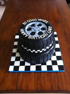 a birthday cake made to look like a tire on top of a checkered table