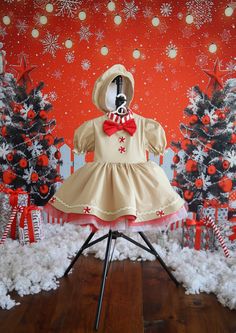 a dress on a tripod in front of a christmas backdrop