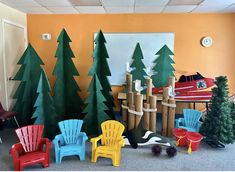 there are many chairs and trees in the room with each one's own chair