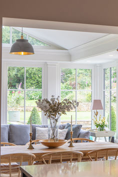 a living room filled with furniture and lots of windows