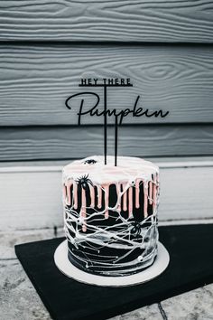 a black and white cake sitting on top of a table