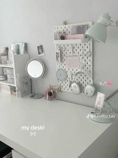 a white desk topped with lots of clutter