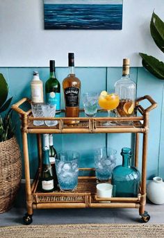 a bar cart filled with liquor bottles and glasses