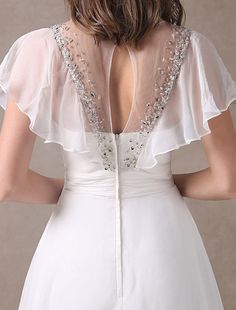 the back of a woman wearing a white dress