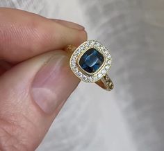 Victorian 2 CT Blue Cushion Cut Sapphire Diamond Ring 10K 14K 18K Solid Yellow Gold Wedding Ring Surrounding Round Cut Diamond Design Ring R I N G M E T A L ✥ Metal : 10K 14K 18K Solid Yellow Rose and White Gold, 925 Sterling Silver ✥ Metal Clarity : 100% Pure ✥ Stamp/Hallmark : Yes. Will be Indicated Inside The Ring M A I N S T O N E S ✥ Type : Sapphire Diamond ✥ Center Diamond Shape : Cushion Brilliant Cut Diamond ✥ Center Diamond Weight : 2 CT ✥ Center Diamond Color : Blue ✥ Side Diamond Shape : Round Cut Diamond ✥ Side Diamond Weight : 0.48 CT ✥ Clarity : VVS1 ✥ Diamond Cut : Excellence R I N G S I Z E S ✥ All Ring Size are Available ✥ Free Sizing ✥ If You Have any Questions With Regards to Sizing Please Contact as ✥ Please Send me a Message If You Need a Size not Listed S H I P P I N 14k Gold Sapphire Diamond Cut Ring, Yellow Gold Sapphire Ring With Halo Diamond Design, Gold Sapphire Diamond Ring With Halo Design, Yellow Gold Sapphire Ring With Halo Design, Gold Sapphire Ring With Halo Design, Heirloom Yellow Gold Sapphire Ring With Halo Setting, 14k Sapphire Promise Ring, Gold Cushion Cut Sapphire Ring Fine Jewelry, Formal 14k Gold Sapphire Ring With Halo Design