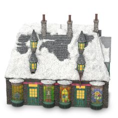 a toy house with snow on the roof and windows in front of it that is decorated like a world map