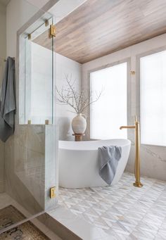 a white bath tub sitting next to a window