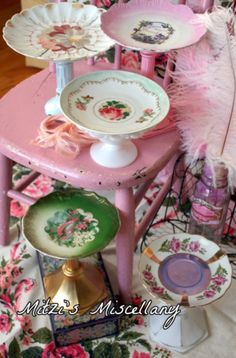 a pink table topped with lots of plates