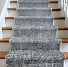 a carpeted staircase leading up to the second floor