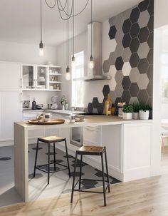 a kitchen with two stools in front of the counter and an island next to it