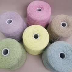 four spools of yarn sitting next to each other