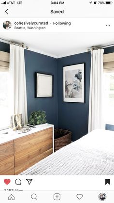 a bedroom with blue walls and white curtains