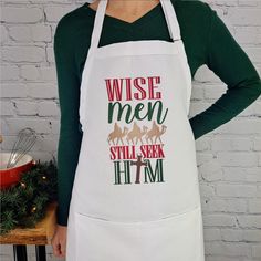 a woman wearing an apron that says wise men, still seek him