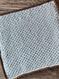 a crocheted dishcloth sitting on top of a wooden table