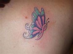 a woman's back with a butterfly tattoo on it