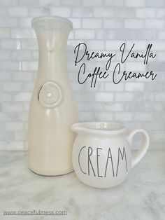 a cream colored pitcher next to a ceramic creamer with the words creamy vanilla coffee cream written on it