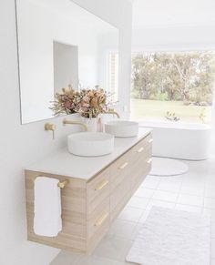 a bathroom with two sinks and a large mirror