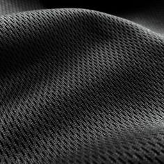 black and white photograph of fabric textured with dark colors, closeup view photo