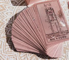 several pink playing cards sitting on top of a table