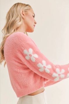 This soft and sweet cropped cardigan in a bold barbie pink features covered buttons and a white floral pattern down the sleeves. Pair this adorable cardigan with a jeans for a more casual look or dress it up for a date night with a white skirt and heels. Trendy Pink Fitted Cropped Sweater, Trendy Fitted Pink Cropped Sweater, Chic Pink Cropped Sweater For Winter, Trendy Long Sleeve Cropped Sweater For Spring, Cute Long Sleeve Spring Cardigan, Feminine Long Sleeve Cardigan For Spring, Pink Cozy Cropped Sweater For Spring, Cozy Pink Cropped Sweater For Spring, Cozy Pink Long Sleeve Cropped Sweater