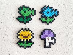 four perler beads with different designs on them