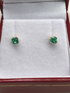 AAA+ fine quality Colombian emerald studs set in 14K yellow gold. vivid-green emeralds with incredible transparency, accented by a simple double-prong 14k yellow gold mount, allowing for the emerald to be shown in full view. The earth mined, green Colombian emeralds have a desirable lush green color with excellent qualities. These earrings are ideal for everyday use and are the perfect accessory to any outfit. Total Carat Weight: 0.24tcw Setting Style: Double Prong Setting Material: 14K Yellow, Gold Emerald Earrings With Brilliant Cut, 14k Gold Round Earrings For May Birthstone, Yellow Gold Round Earrings For May Birthstone, Yellow Gold May Birthstone Round Earrings, Yellow Gold Emerald Birthstone Earrings, Green Brilliant Cut Earrings For May Birthstone, Green Brilliant-cut Earrings For May Birthstone, Round Green 14k Gold Earrings, 14k Yellow Gold Earrings With Birthstone