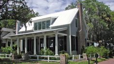 a large house with white pillars and windows