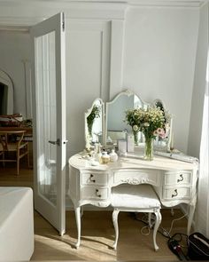 a white dressing table with flowers on it