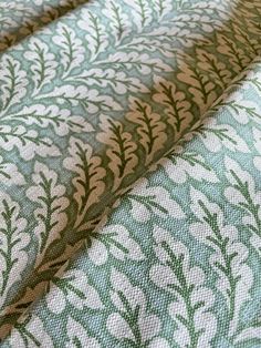 green and white fabric with leaves on it