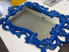 a blue mirror sitting on top of a table