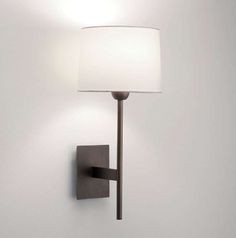 a wall light with a white shade on it