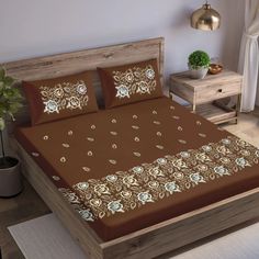 a bed with brown and white flowers on it