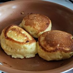 three pancakes are sitting in a frying pan