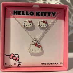 two hello kitty necklaces in a pink box with the word, fine silver plated