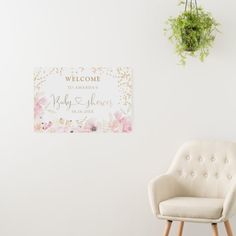 a welcome sign is hanging on the wall next to a chair and potted plant