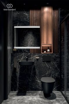 a bathroom with black marble and wooden accents, including the sink and toilet area in the corner