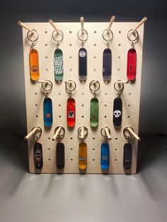 a rack with several different colored skateboards hanging from it's sides and hooks on each side