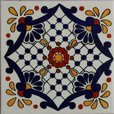 an artistic tile design with orange, blue and red flowers on white tiles in the shape of a flower