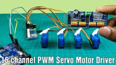 a person holding a small device with four wires attached to it and the words, 16 channel pwm servo motor driver