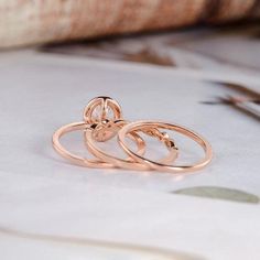 three gold rings sitting on top of a table