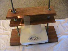 a white sewing machine sitting on top of a wooden stand next to a rug and lamp